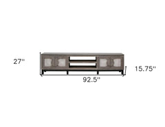 Gray solid wood cabinet TV stand with enclosed storage, featuring a distressed finish and decorative doors. Dimensions: 93" x