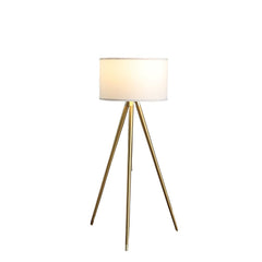 Gold metal adjustable tripod floor lamp with a white linen drum shade, featuring three slender legs for stability.