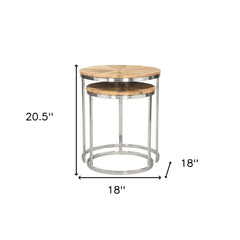 Set of two natural and silver solid wood and iron round frame nested tables, featuring a sleek design and modern finish.
