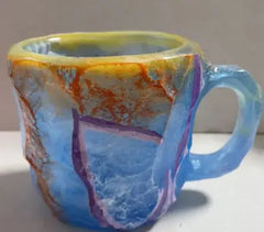Close-up of crystal-effect resin mug exterior showing gemstone color depth and translucent finish