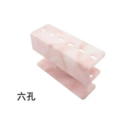 Acrylic Pink Marble Eyelash Tweezer Rack Organizer with 6 holes, ideal for storing beauty tools in a sleek and compact design.