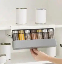 Mounted spice rack organizer with six filled jars, demonstrating stylish and space-saving spice storage in kitchen cabinets.