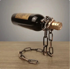 Floating wine bottle held by a metal suspension chain holder in copper finish, perfect for unique kitchen or bar decor.