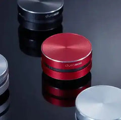Red duraMOBI Humbird Bone Conducting Speaker among other color variants, highlighting compact and stylish audio gadget.