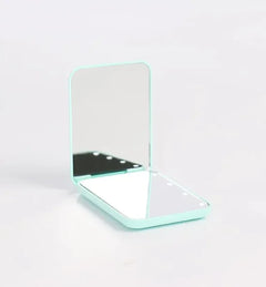 Portable makeup mirror with LED lighting used for foundation application in low-light room
