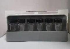 Spice organizer with six empty jars featuring black lids, suitable for customizable spice storage in compact kitchens.
