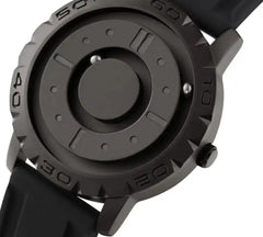 Detailed view of Men's Magnetic Ball Watch in gunmetal finish, showing recessed tracks and magnetic ball bearings for time display.