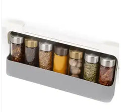 Wall-mounted spice rack filled with assorted spice jars, showcasing organized spice storage for kitchen efficiency.