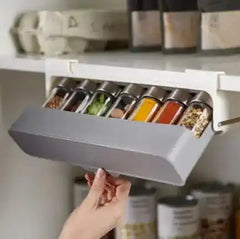 Hanging Kitchen Spice Rack Organizer being tilted open for access, showing functional and user-friendly spice storage.