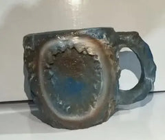 Gemstone-style resin mug showing agate-inspired swirl pattern in warm earth tones